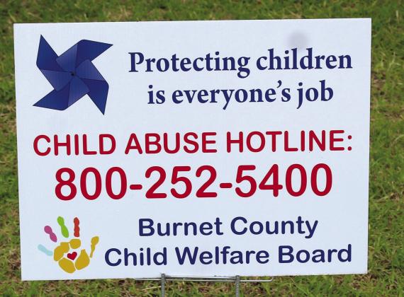 The Burnet County Child Welfare Board public announcement sign is planted in Burnet near the County Courthouse west entrance.