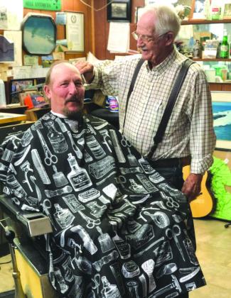 The late Tom Hullum, owner of Hullum’s Barbershop on Burnet’s downtown square, spent his days cutting his clients hair and catching up on the latest community news. In this photo he is pictured with Glenn Willis in 2019, a long-time client.