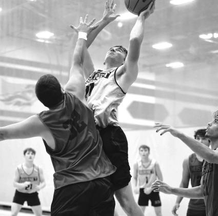 Bulldog basketball player Jacob Koenig muscles his way past a Mustang for a basket during summer league play at Georgetown Eastview. Photos by Wayne Craig/Clear Memories with three treys and one two-point bucket.