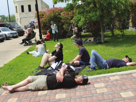 Several unnamed spectators chilled out before the eclipse April 8 in Burnet at the County Courthouse. Raymond V. Whelan/Bulletin