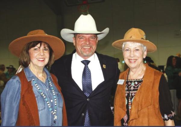 Celebrating last year's successful Chuck Wagon Chow Down dinner and auction are, from left, Darlene Hargett, Auctioneer Scotty Gibbs, and Brenda Eubank. To bid using the online auction, visit www.one.bidpal.net. See story on Page 3. Contributed photo