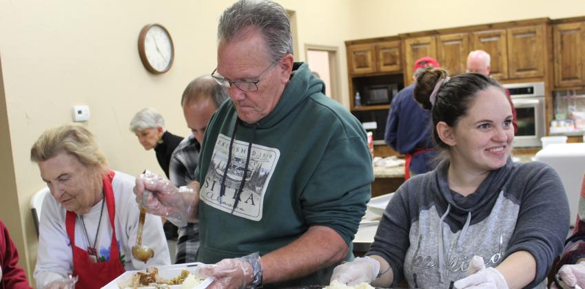 From left, Patty Murray, Paul Brent and Stacie Heuss assembled Thanksgiving meals for hundreds of hungry guests Nov. 23 in Burnet at Vanderveer Church of Christ, 102 S. Vandeveer St. Raymond V. Whelan/Bulletin