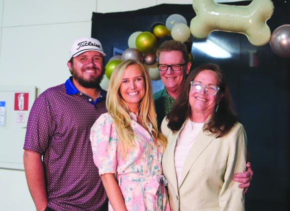 Derek Steffeck, Remington Jackson, Holly and Brian Jackson smiled for the camera at the Wags to Riches fundraiser Saturday, April 27 benefitting Hill Country Humane Society at the YMCA of the Highland Lakes in Burnet.