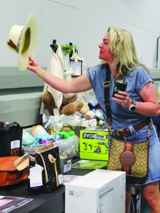 Amy Corley admired the silent auction items available April 27 at the Wags to Riches Hill Country Humane Society fundraiser held at the YMCA of the Highland Lakes in Burnet.