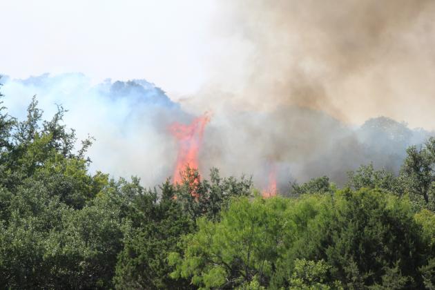 Firefighters from 18 fire departments, the Texas Forest Service, the Lower Colorado River Authority and Balcones Canyonlands National Wildlife Refuge battled a wildfire which consumed at least one home in The Trails at Horseshoe Bay and another in Blue Lake Thursday, Aug. 13.