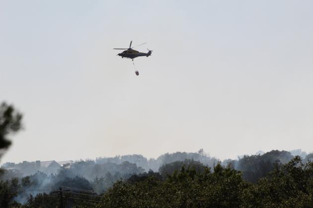 Firefighters from 18 fire departments, the Texas Forest Service, the Lower Colorado River Authority and Balcones Canyonlands National Wildlife Refuge battled a wildfire which consumed at least one home in The Trails at Horseshoe Bay and another in Blue Lake Thursday, Aug. 13.