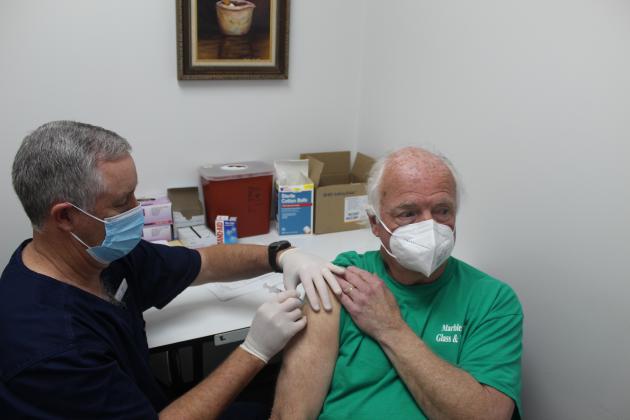 Bay Pharmacy pharmacist Jason Pool, left, administers a single-shot Johnson & Johnson Janssen COVID-19 vaccine to Horseshoe Bay resident Tom Mills on Monday, March 8. The pharmacy was the first site in Llano or Burnet County to receive the newly approved vaccine.