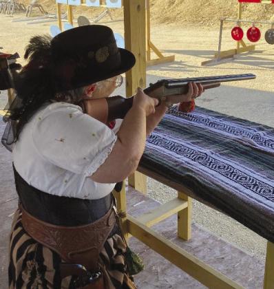 Ms. Prickly Pear Peggy, aka Peggy Huddelston, Fischer, Texas aims her 12ga Coach Gun.