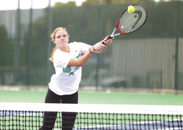 Lady Bulldog senior Kendall Bible stretches to make a nice return for a point in mixed-doubles play last week.