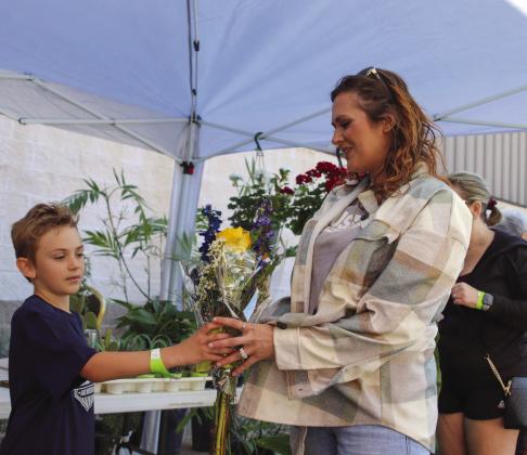 Luke Griffith shared a bouquet with his mom Megan, during the 23rd Annual Hill Country Lawn and Garden Show on March 25 in Burnet. Find more photos on Page 3A. Martelle Luedecke/Luedecke Photography