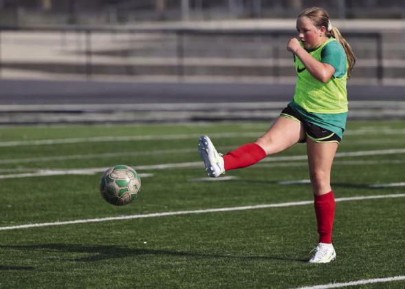 Youth soccer camp participant, Piper Horner, sends a kick toward the goal during scrimmage play on Wednesday at Bulldog Stadium.