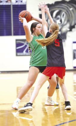 Feeling defensive pressure Burnet’s Landri Lewis pulls up the ball and looks to pass to a teammate. The Lady Dawgs are undefeated in summer league play in Lampasas.