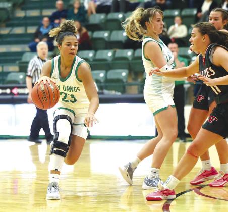 Burnet Lady Dawg senior, MaeSyn Gay, looks for a lane at the top of the key while picking up some assistance from Sierra Schaefer.