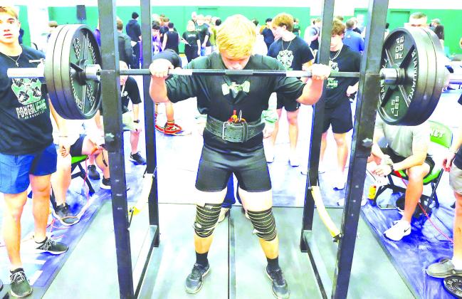 Luke Hudgins gets his mind set on his upcoming lift before settling under the bar at Thursday’s meet. Hudgins posted a 410 pound squat and totaled 1,195 in the opening meet.
