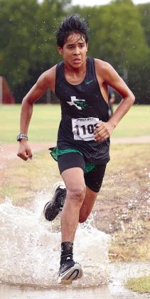 The Burnet cross country team raced in some harsh conditions in 2022 including the race pictured above where Isaias Zarate splashes through the path at their first race of the season.