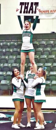 BHS cheer bases Diana Mendez, Zoe Ward, and Haylee Williams hold flyer Aubrey Keith in the air during the girls’ exhibition performance on Wednesday.