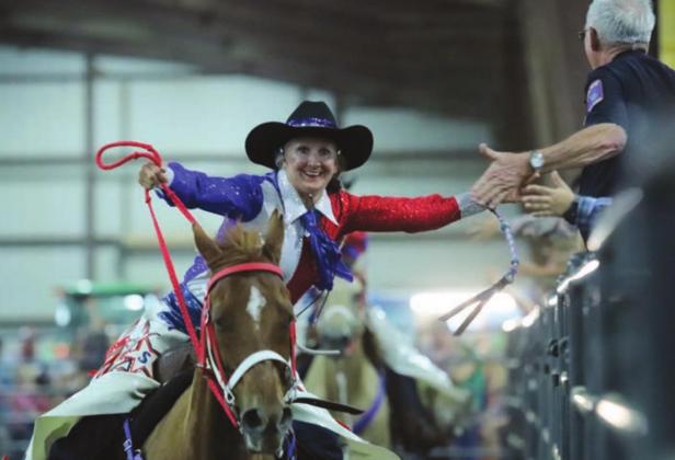 Ellen Rigsby of TSR connects with the crowd. The uniformed gentleman is Kenneth Poe, who is in charge of the Llano Rodeo.