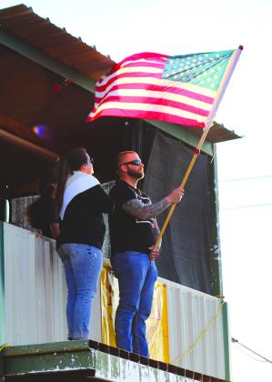 Army veteran Travis Skimmer of the Burnet County Sheriff’s Office, held the American Flag during the opening ceremony of the Demolition Derby Saturday, Oct. 14 in Burnet.