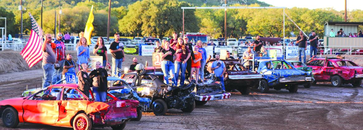 During the National Anthem, spectators viewed the demolition cars that would smash later in the evening Oct. 14 at the Burnet Demolition Derby at the Burnet County rodeo arena.