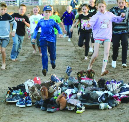 Participants in the shoe scramble sprint to the pile to claim their shoes and return to the starting line for a $20 prize before the Oct. 14 Demolition Derby in Burnet. Loud roaring engines of the demolition cars encouraged Nakoa Dipprey to wear his noise reduction headphones during the Demolition Derby Saturday night in Burnet.
