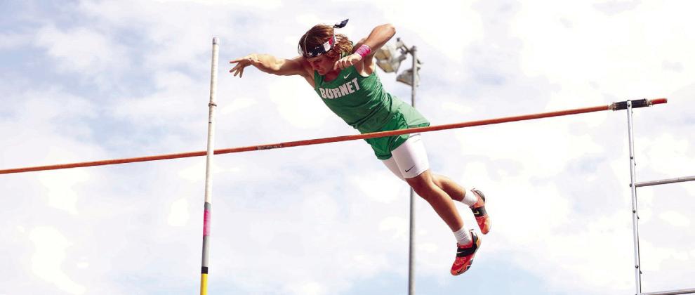 Burnet vaulter, Brady Rygaard, clears the bar and pushes away his pole during last week’s Badger Relays. Rygaard placed first with a vault of 14’. Photos by Wayne Craig/Clear Memories