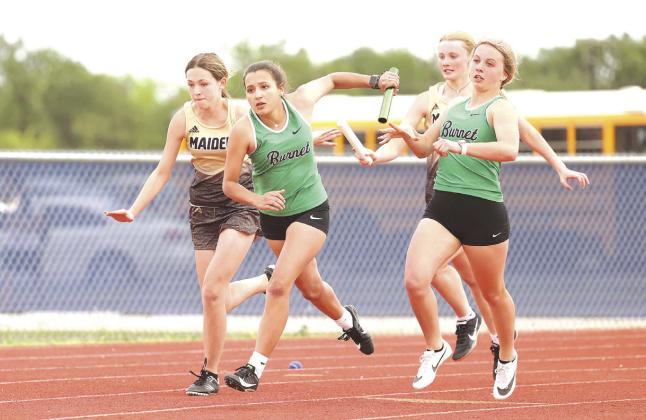 Payton Smith hands off to Briana Barrios on turn one during the 400 meter relay. The Burnet girls placed second.