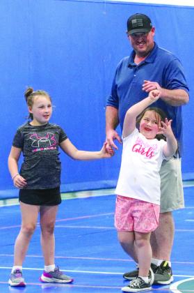 Brett Powell danced with his daughters Charleigh and Coraleigh at the DIVA Dawgs and Bulldog BROS Family Dance and Dodgeball held at the YMCA Feb. 18.