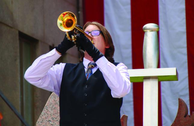 Burnet High School senior Seth Wall plays “Taps” May 29 in Burnet at the Courthouse Square as the Memorial Day ceremony concludes.