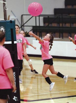 Burnet camper Adley Shelburn bumps the ball during game play activities at Wednesday’s youth volleyball camp.