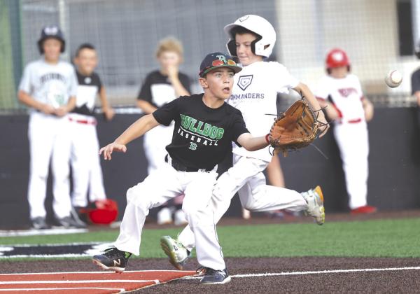 Cooper Reese races home and Bradyn Houston waits for the ball to make the tag. Baseball campers were treated to live game play at the conclusion of Wednesday camp.