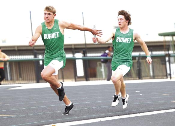 Dash Denton passes the baton to Grant Jones during the varsity boys 400 meter relay in Burnet. As a team the Bulldogs placed fourth at their home meet.