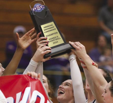 Hardin-Simmons University guard Paris Brinkley Kiser recently hoisted the American Southwest Conference championship trophy after her team defeated Trinity University. Kiser graduated from Burnet High School five years ago. Contributed photo