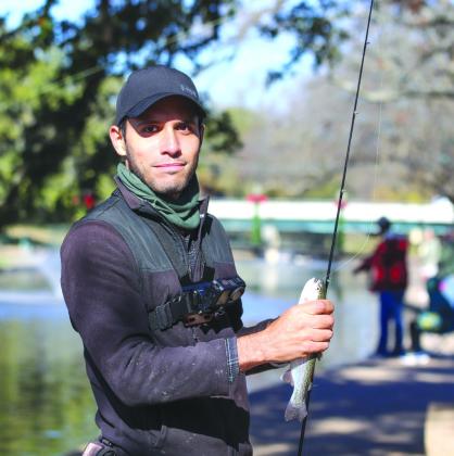 Steven Garcia held the rainbow trout he caught after the Texas Parks and Wildlife Department released 750 Rainbow Trout at Hamilton Creek Park Thursday, Dec. 28.