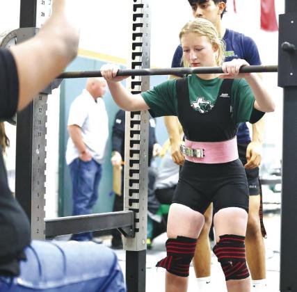 Powerlifting has many mental as well as physical aspects. Above, Halle Maxwell gets her mind set on her upcoming squat attempt. Maxwell finished second and earned her first state powerlifting ticket.