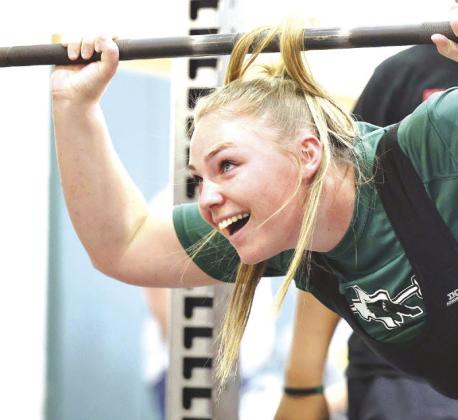 A huge smile emerges on the face of Maddi Moise as she sees white lights flash signifying a good squat. The 280 pound lift was a new personal record for Moise who earned a regional championship and spot at state.