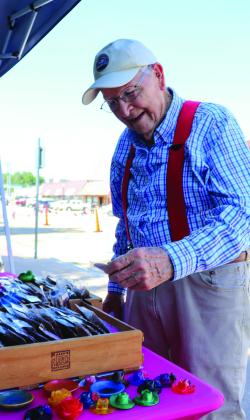 Richard Spinner, retired pastor from the Burnet Presbyterian Church, checks out the wares of the vendors during the Farmer’s Market on Saturday morning in downtown Burnet on the courthouse square. See more photos on Page 5. Martelle Luedecke/Luedecke Photography