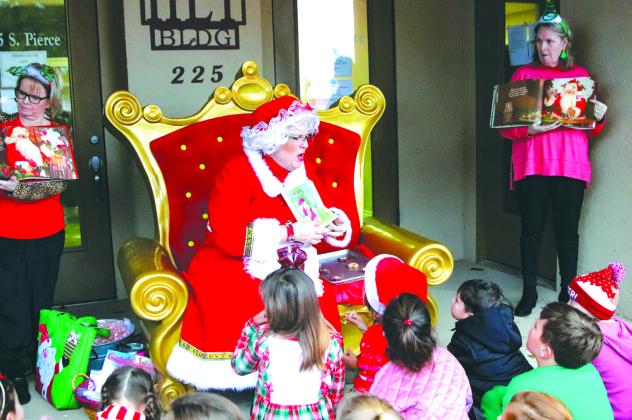 Photos by Martelle Luedecke/ Luedecke Photography Children of all ages gathered around Mrs. Claus (Darlene Denton) to hear her read to celebrate the Lighting of the Square Nov. 25 at the Burnet County Courthouse in Burnet.