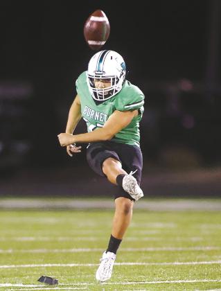 Bulldog kicker Sam Rodriguez puts the ball in play Friday night. Rodriguez made all three PATs and booted a 37-yard field goal as time expired in the first half putting Burnet up 10-0 over the Mustangs. Photos by Wayne Craig/Clear Memories