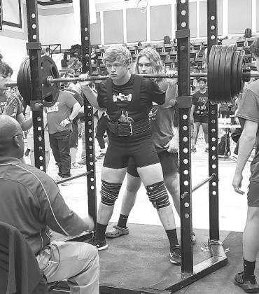 Burnet lifter, Luke Hudgins, waits for the judge’s command to rack the weight after pushing up a 475 pound squat. Hudgins earned a regional bronze medal with a 1,295 total.