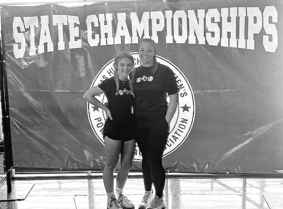 Burnet was represented by two Lady Dawg lifters at Friday’s state meet. Pictured above Abby Smith and Maddi Moise standing at the State Championship banner before the meet. Contributed photo