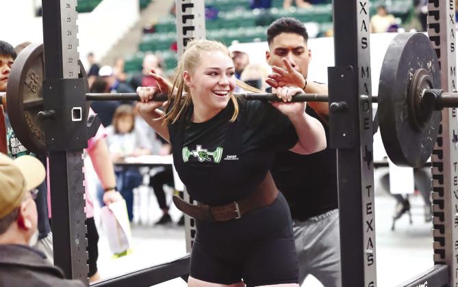 After successfully pushing up her third squat, 260 pounds, a smile emerges on the face of Maddie Moise. The Lady Dawg lifter went on to qualify for state after finishing second in the region with a 740 pound total.