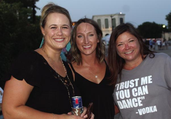 From left, Burnet Chamber of Commerce Marketing Manager Teryl McFerrin, Burnet County Tourism Director Blair Manning and Rebecca Noah from the Herman Brown Free Library enjoy the Jackson Jam July 15 in Burnet at the courthouse square.