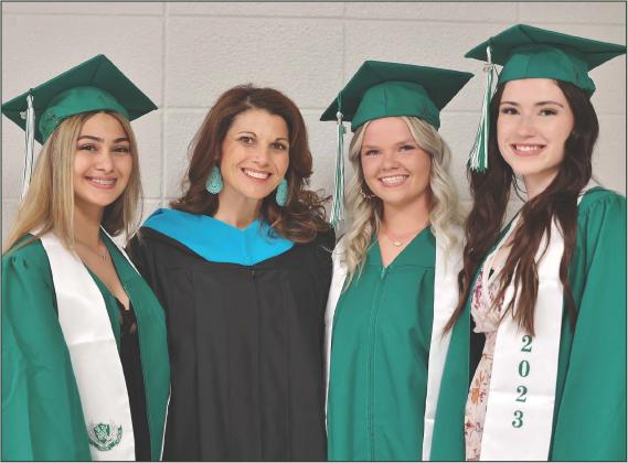 Burnet High School senior cheerleaders, from left, Emma Corona, Chloe Langbein and Adelina Boyd pose with their cheer coach Kristen Atwood just before graduation ceremonies. Pick up your copy of the Class of 2023 graduation special section at the Bulletin office, 220 S. Main St. in Burnet. Wayne Craig/Clear Memories