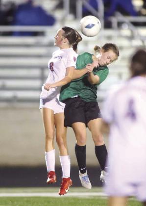 Kaycie Banton goes head-to-head with a Lady Texans during a very physical game on Friday. The non-district contest ended in a 3-3 tie.