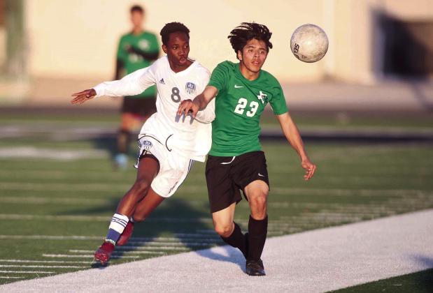 JV Bulldog Victor Hernandez-Escobedo does battle near the sidelines with a Jarrell player on Tuesday. The Dawgs earned a 2-1 district victory over the Cougars. Photos by Wayne Craig/ Clear Memories