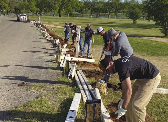 LCRA employees installed a fence at the Llano River Golf Course in Llano during LCRA’s Steps Forward Day on April 12.