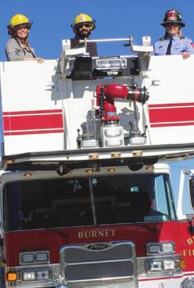 Former Chamber Executive Director Kim Winkler (left) was invited by the Burnet Fire Department for a ride in a newly purchased fire truck. Contributed/Kim Winkler