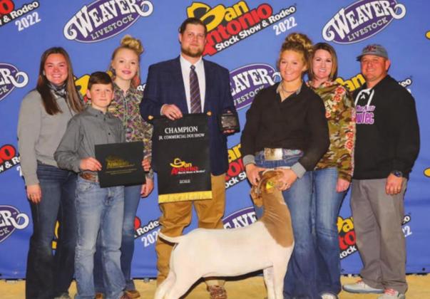 McKenzie Evans earned overall Grand Champion Doe. She is pictured at the San Antonio Stock Show and Rodeo in February with family and friends and show judge Jake Warntjes as well as in the arena with other competitors. See more photos on Page 3. Contributed/Mikayla Herron