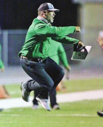 You might as well jump, jump! Burnet head football coach Jerod Rye can’t contain his excitement as his Bulldog defenders stuff Fredericksburg on a fourth down attempt late in the fourth quarter. Wayne Craig/Clear Memories
