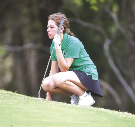 Cambria Neenan studies the lay of the land between her ball and the hole. Neenan earned an alternate spot at regional with her play at district.